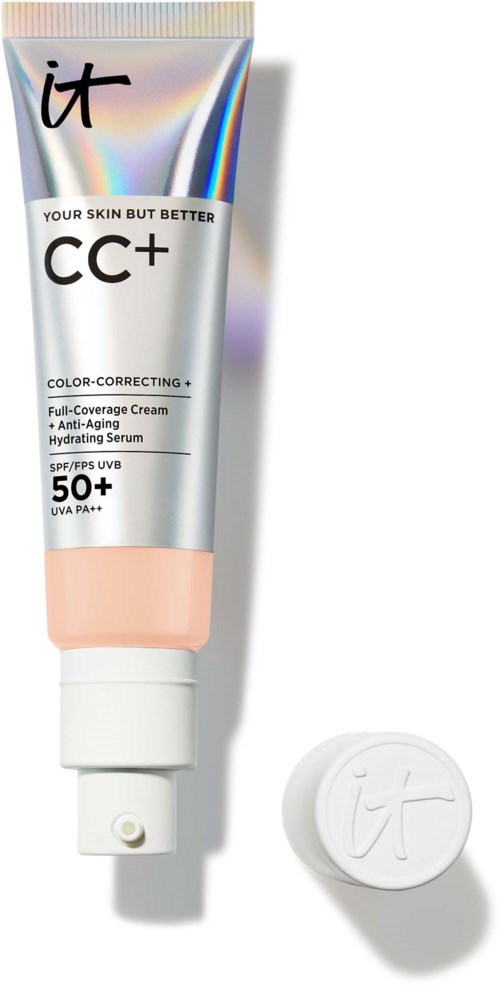 A tube of CC cream with SPF 50+ and a white cap, placed next to its seal on a white background.