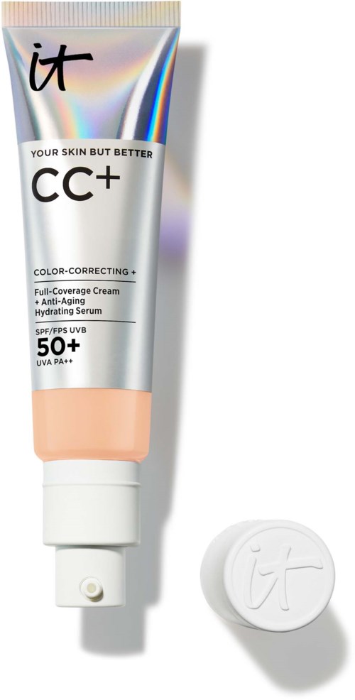 Eine Tube mit CC+-farbkorrektierende Creme mit SPF 50+ und einem runden Deckel daneben.