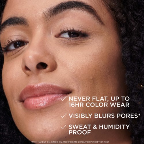 A woman smiling gently with makeup, showcasing skin benefits like pore blur, long-lasting color, and sweat proof features.