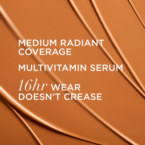 Text on a cosmetic product bottle promoting good skin coverage and serum longevity.