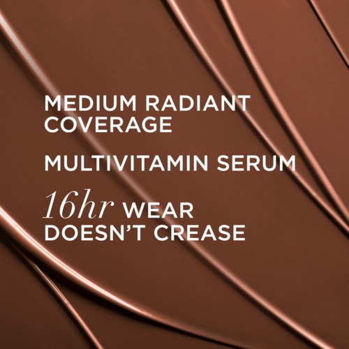 Text advertising multivitamin serum highlighting its coverage, long wear, and smooth application on a metallic background.