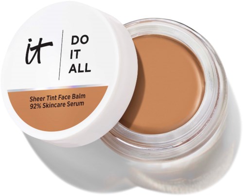 Auki oleva lasipurkki beigeä kasvovoide ja valkoinen kansi, jossa lukee it DO IT ALL ja kuvaus Sheer Tint Face Balm.