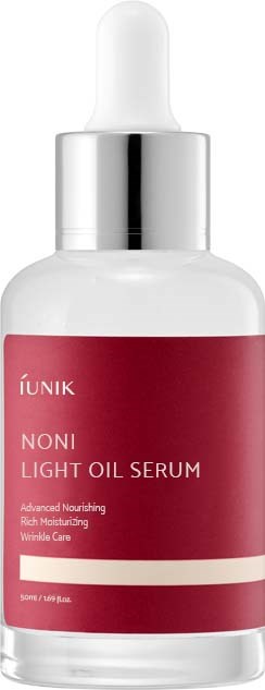 Flesje met lichte olie serum met pipetdop, roze label en merknaam 'ÑUNIK'.