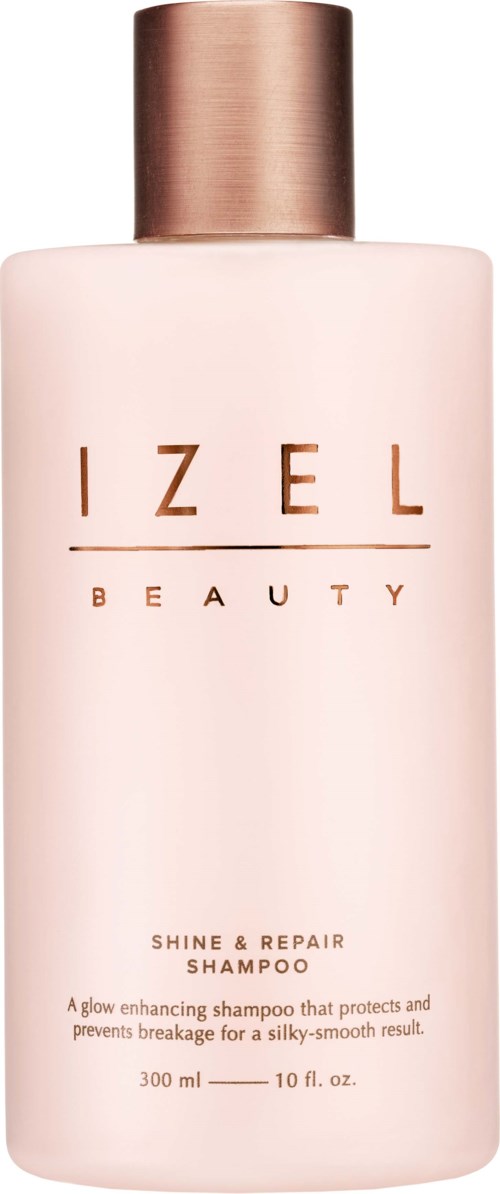 Roze fles met roségoudendop, gelabeld "IZEL BEAUTY" en "SHINE & REPAIR SHAMPOO."