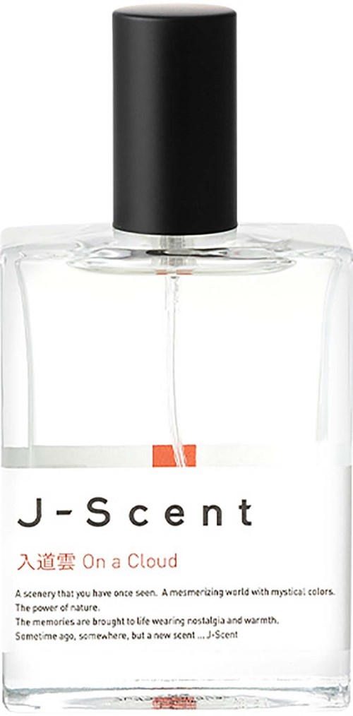 Tydlig parfymflaska med svart lock, etiketten säger J-Scent On a Cloud, inkluderar doftbeskrivning och poesi.