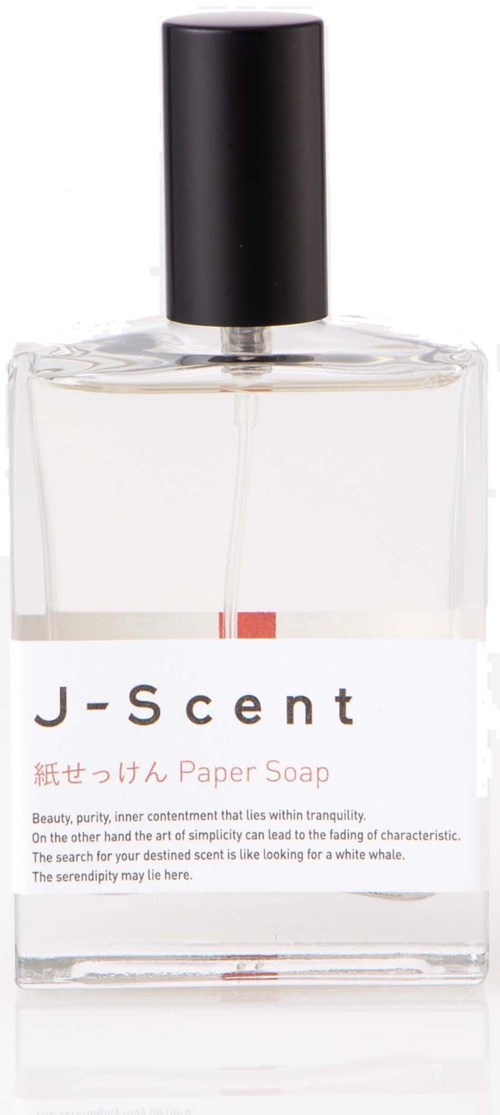En klar glasflaska med svart lock med parfym märkt J-Scent Paper Soap.