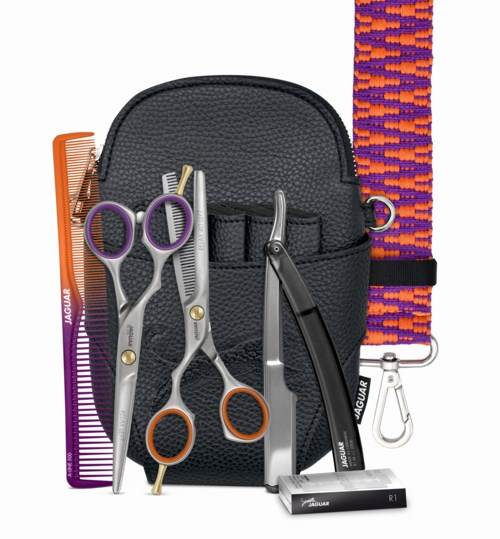 A black pouch holds scissors, a comb, and hair cutting tools. There is a colorful hair strap and a small box.