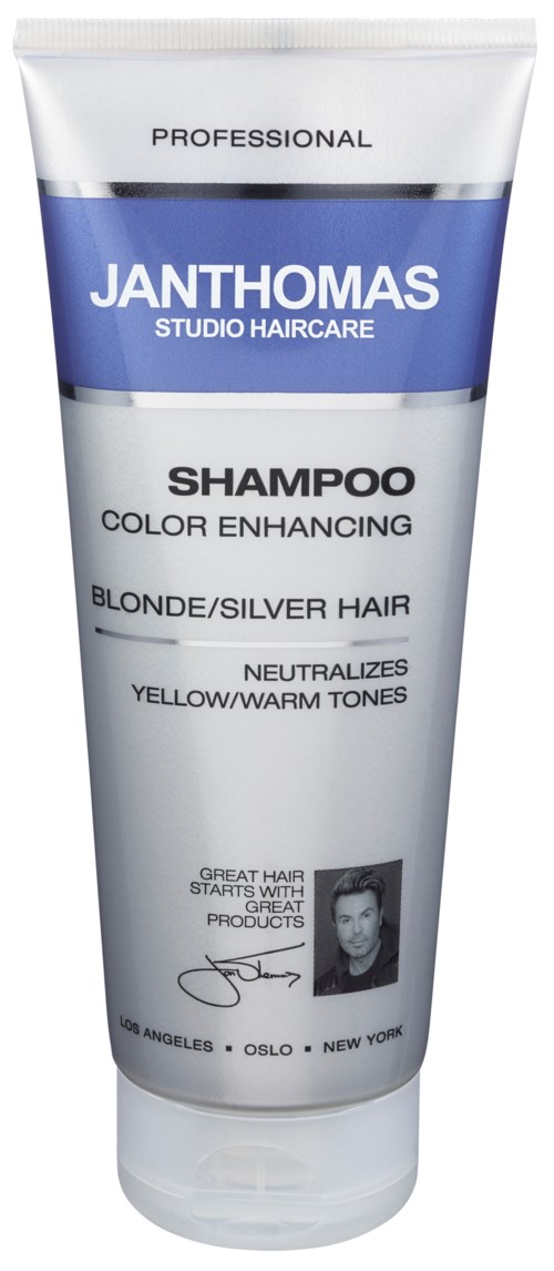 A shampoo tube labeled for blond or silver hair, neutralizes warm tones, with a black-and-white image and signatures.
