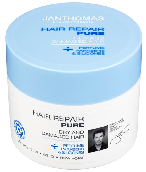 A white jar with a blue lid labeled 'Hair Repair Pure' for dry and damaged hair, includes perfume, parabens, and silicones.