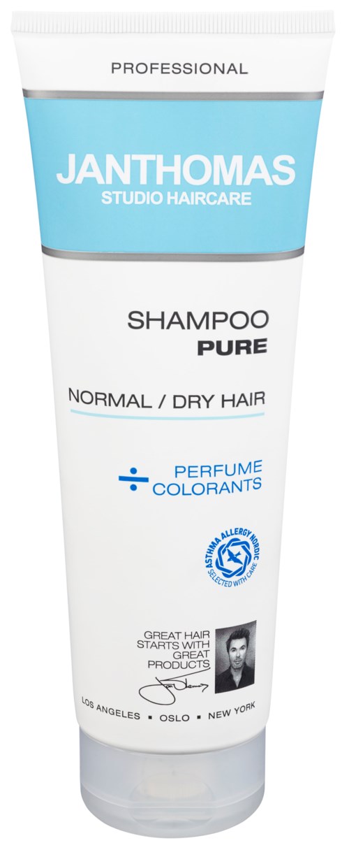 A white shampoo bottle with blue and black text, labeled for normal or dry hair, with perfume and colorant information.