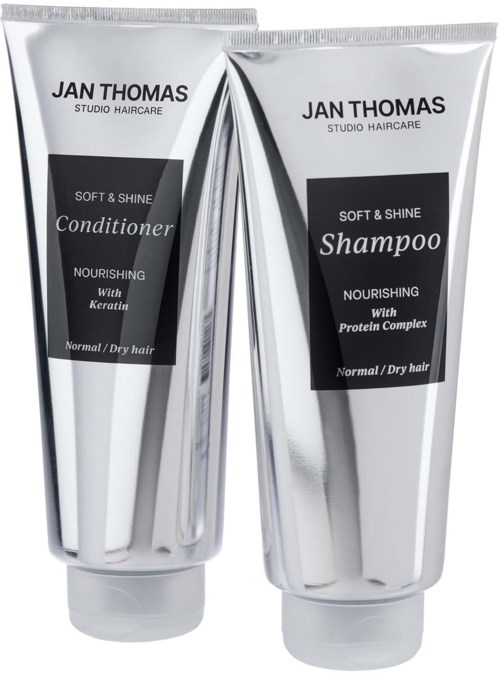 Two silver tubes of Jan Thomas hair products, one for shampoo and one for conditioner, labeled for normal or dry hair.
