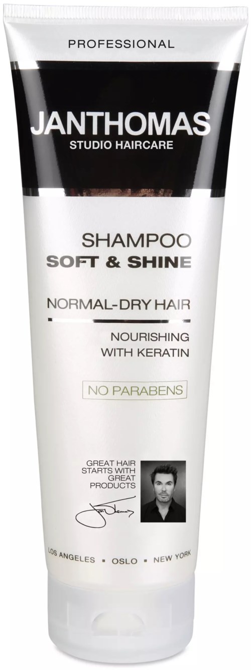A white and black shampoo tube for normal to dry hair, nourishing with keratin, no parabens, and designed for professional use.