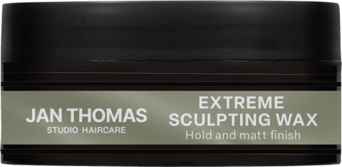 A black jar labeled 'Extreme Sculpting Wax' from Jan Thomas Studio Haircare, designed for hold and a matte finish.