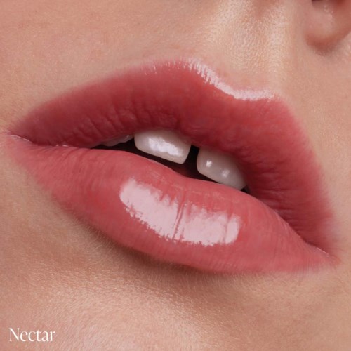 Close-up of lips with gloss, slightly open showing teeth, skin visible around lips.