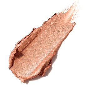 En provbit av peachfärgad makeup eller kosmetisk kräm med en krämig, jämn textur.