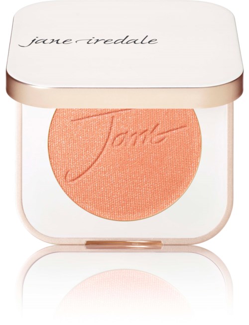 En rund ljusrosa rouge i en vit behållare med ett silverlock med Jane Iredale skrivet på.