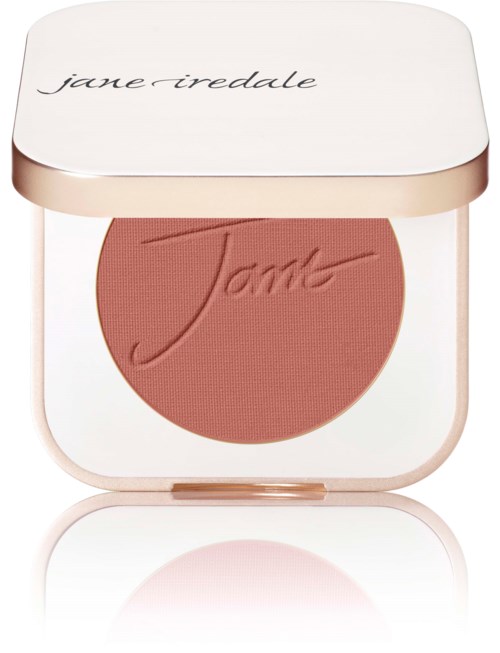 En rougekompakt med rund, persikofärgad rouge och vit lock med "jane irredale" skrivet i kursiv.