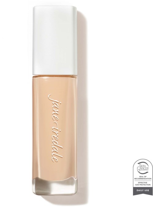A beige liquid foundation in a bottle with a white cap, labeled 'Fiole Verte.'