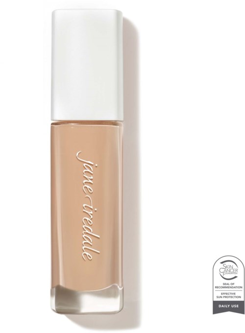 En beige vätska i en genomskinlig flaska med vit topp, märkt 'jane iredelle' och hudvårdsuppgifter.