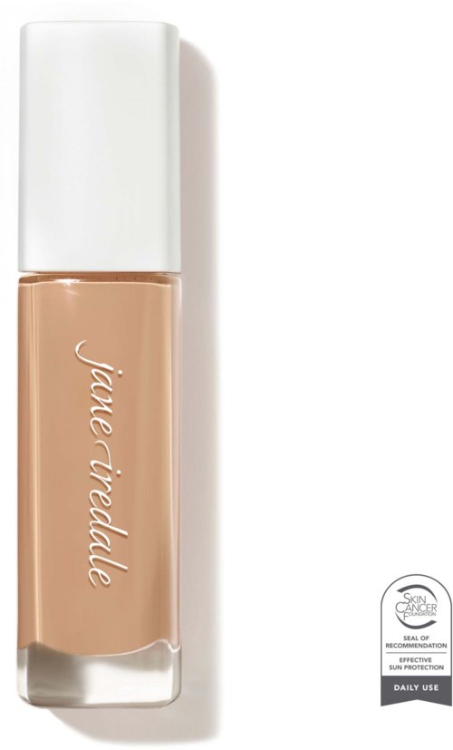 A beige makeup concealer bottle with a white cap and pink writing, recommended for daily use.