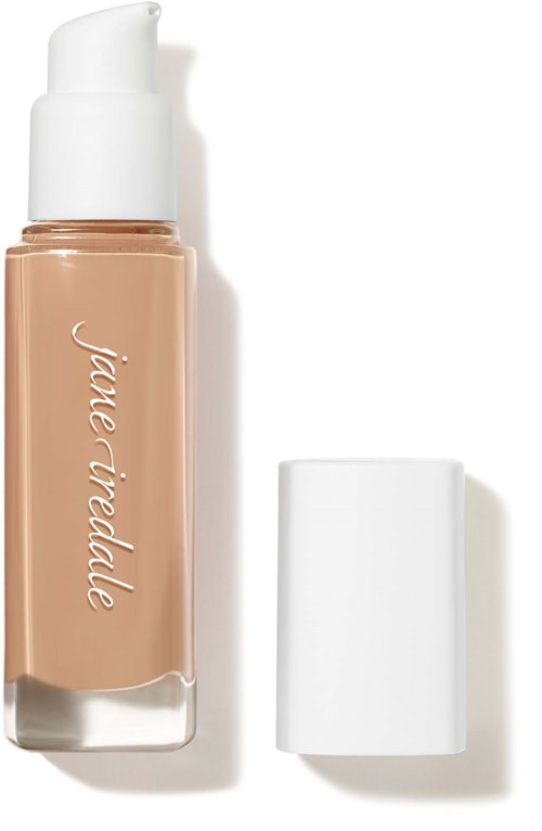 Bottle of liquid foundation with a white cap and brand name on the side.