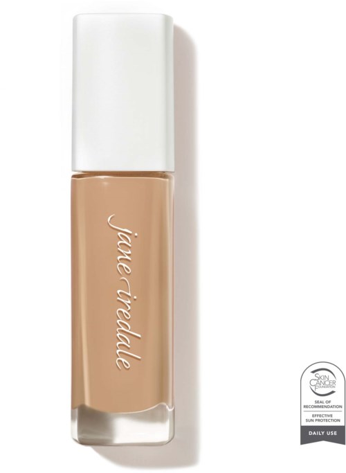 A beige liquid foundation bottle with a white cap and simple white text reading "Jane Iredale."