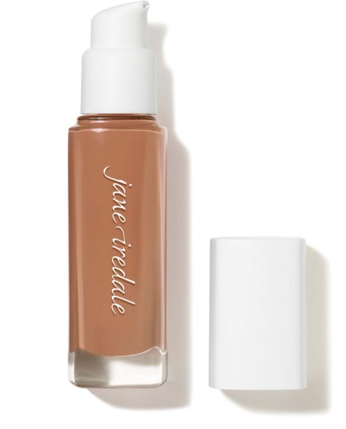 A bottle of liquid foundation with a white cap next to it. The label says 'jiale jade'.