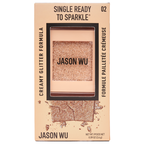 Beige doos met glitterscherp oogschaduw met gebroken deksel en uitgewaaide poeder, etikette 'Jason Wu' en 'Single Ready to Sparkle.'