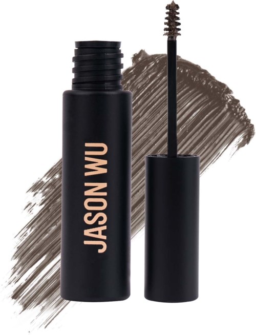 Een zwarte mascara-flacon met borstel, gelabeld 'JASONWU', op een bruine streeppatroon achtergrond.