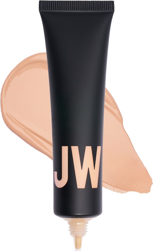Svart tub med "JW" logo, beige grundfärg bakom, och en slät, krämig konsistens.