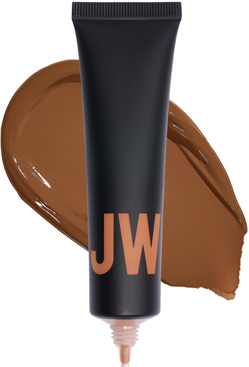 En svart tub med 'JW'-logo, med brunt krämstänk bakom den, ser ut som makeup eller foundation.