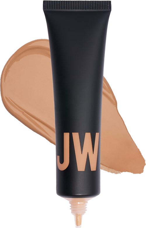 En svart tub med stora 'JW'-bokstäver i persika, med beige makeup eller kräm runt den.