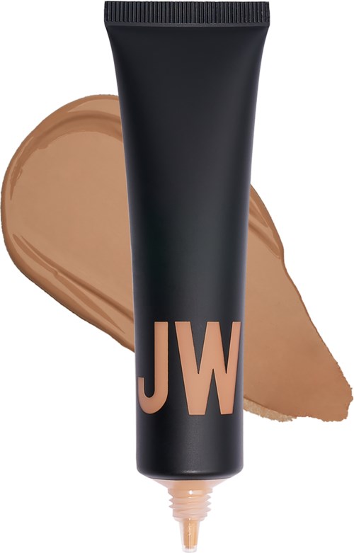 En svart tube märkt 'JW' med beige makeup eller foundation bredvid.