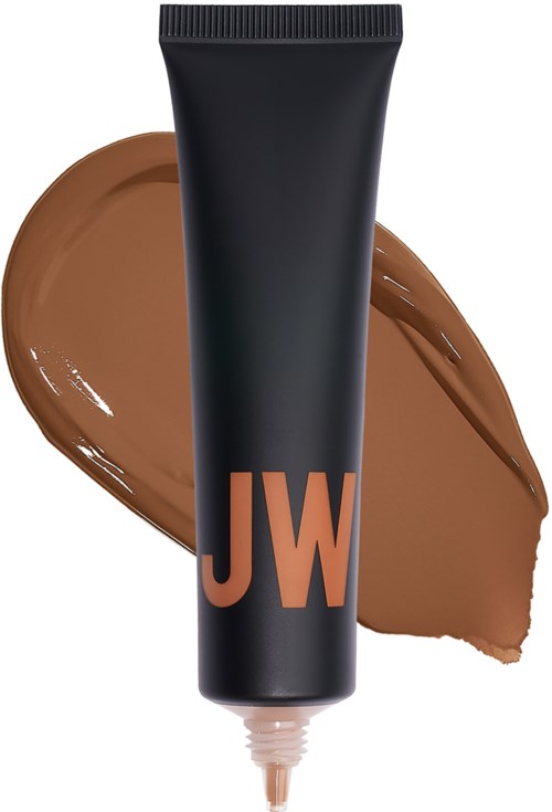 En svart tub med 'JW' logotyp, spridda bruna kräm eller lotion bakom den.