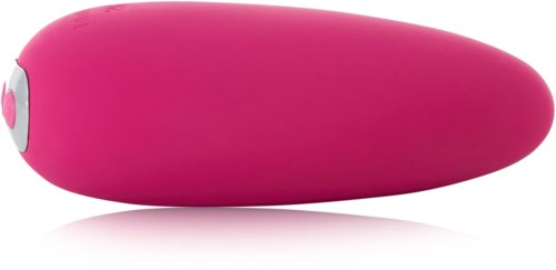 Pinkki esine, joka näyttää sileältä ja pyöreältä, siinä on pieni valkoinen ja pinkki painike sivulla.