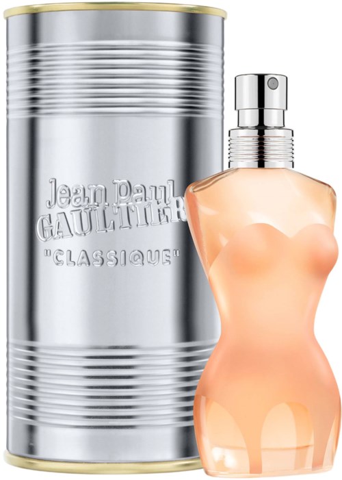 A perfume bottle shaped like a woman, with a silver container in the background, labeled Jean Paul Gaultier.