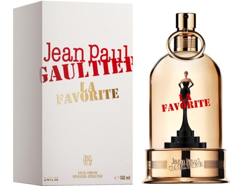 En parfymflaska och förpackning med Jean Paul Gaultier La Favorite och en figur på en trappstegsbas. Flaskan är guldtonad med ett runt guldlock.