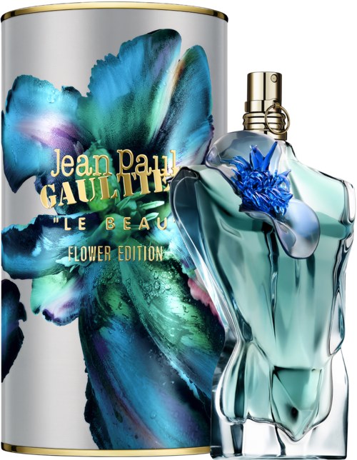 A perfume bottle shaped like a woman’s torso and a floral design, accompanied by a large, colorful cylindrical box.