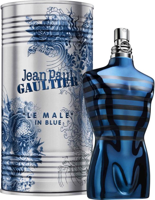 A perfume bottle shaped like a male torso in blue and black, next to a cylindrical box with blue floral designs and text.