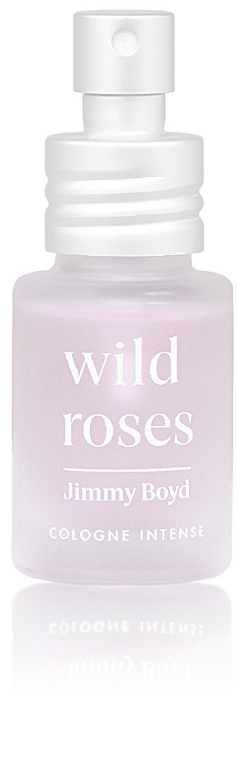 En liten sprayflaska märkt 'wild roses' av Jimmy Boyd, designad för intensiv cologne, i ljusrosa och vitt.
