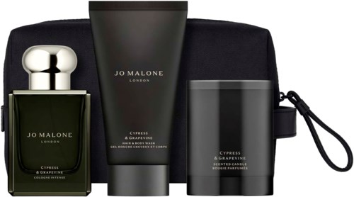 A set of Jo Malone London Cypress & Grapevine scented products including perfume, body lotion, and a candle in black containers.