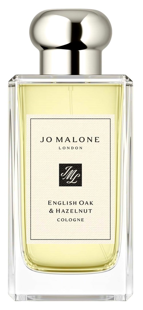 Tydlig parfymflaska med en silverfärgad rund topp och gul vätska inuti. Etiketten står Jo Malone London English Oak and Hazelnut.