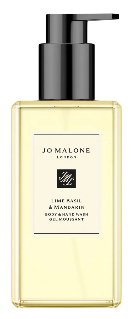 En gjennomsiktig flaske med svart pumpe, inneholder en lys gul kropp og håndvask merket Lime Basil & Mandarin.