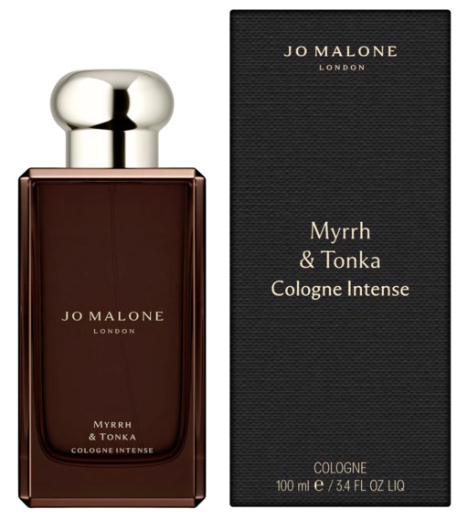 A perfume bottle with a round silver cap and dark brown liquid, next to a black box with gold text.