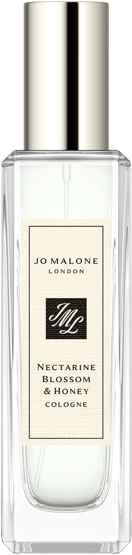 En tydlig glasflaska av Jo Malone parfym med guldkork, märkt Nectarine Blossom and Honey doft.