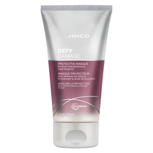 A tube of Joico Defy Damage protective mask for hair, pink and silver colors, including text and branding.