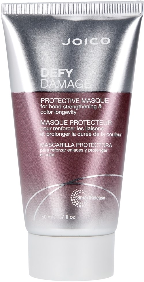 A silver and purple tube labeled Joico Defy Damage Protective Masque for hair.