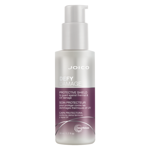 A white bottle with a pump labeled Joico Defy Damage, a protective shield for hair against heat and UV damage.