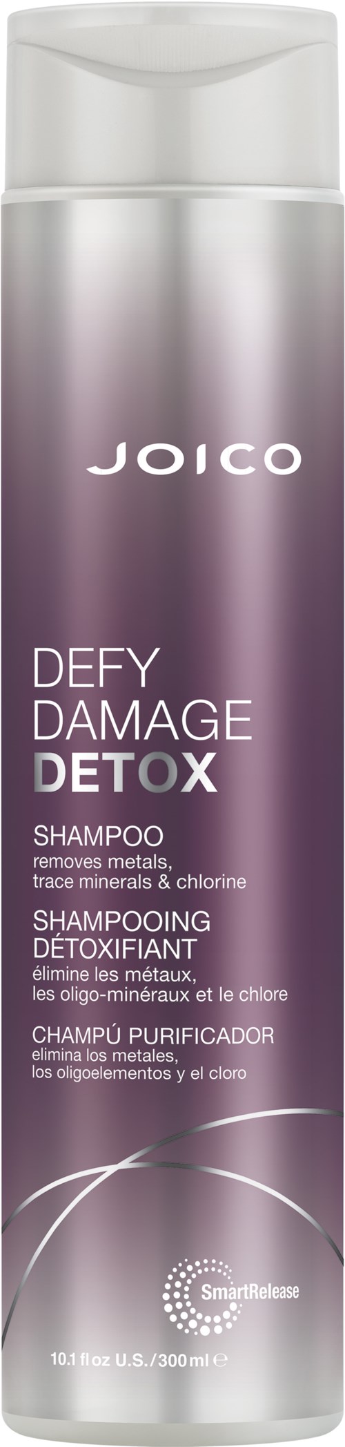 Een lange, paarse shampoo fles met witte dop, gelabeld Joico Defy Damage Detox. De fles heeft wetenschappelijke iconen en tekst.