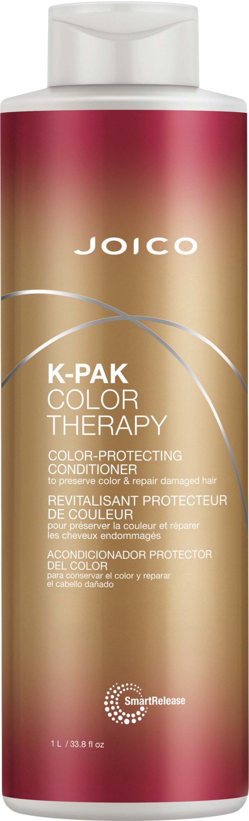 Pitkä, pinkki ja kultainen Joico K-Pak Color Therapy hoitoainepullon etiketti mainitsee väriä suojaavan vaikutuksen.